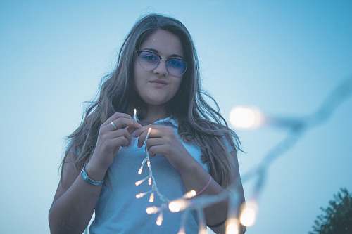 people woman holding string lights person