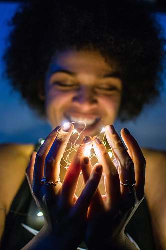 people woman holding white string lights person