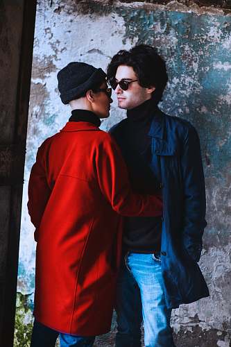 people woman hugging man beside wall person
