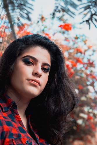 people woman in red and black checkered collared shirt posing for photo person