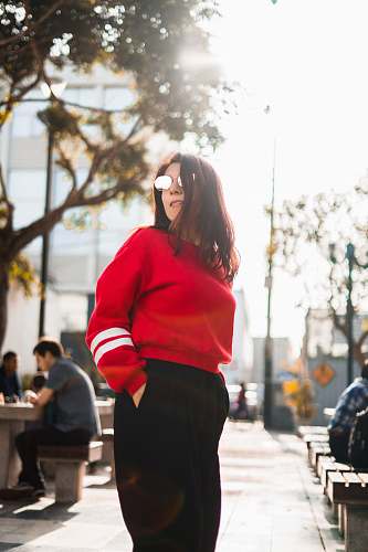 person woman in red and white sweater and black bottoms people