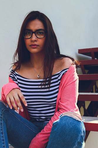people woman in white and black striped shirt taking a selfie person