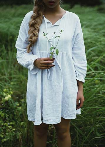 people woman in white long-sleeved dress on gras person