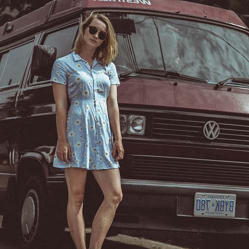 person woman leaning on red Volkswagen van people
