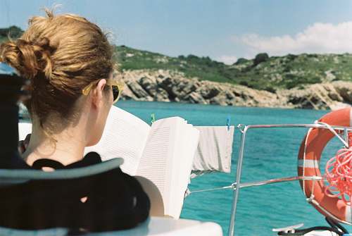 person woman reading book on boat people