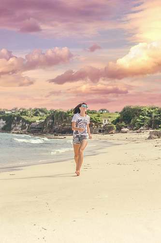 people woman running on sea shore near body of water beach