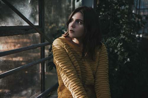 people woman sitting in front of window person