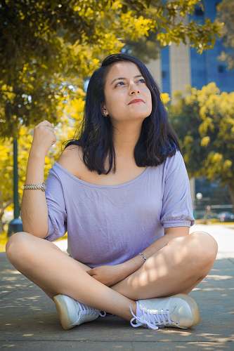 people woman sitting on gray floor person