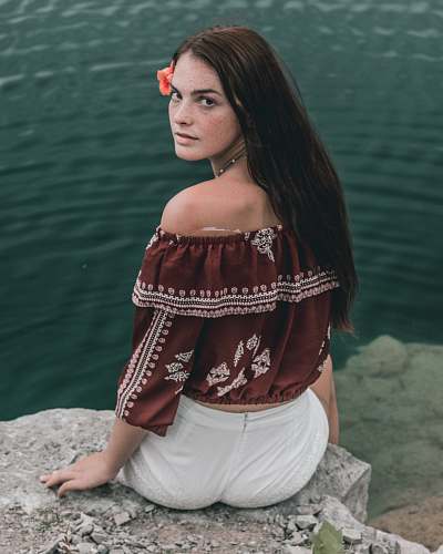 people woman sitting on rock edge person