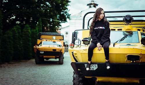 people woman sitting on yellow truck person
