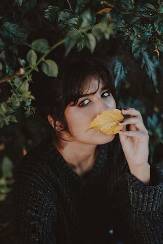 people woman smelling brown leaf person