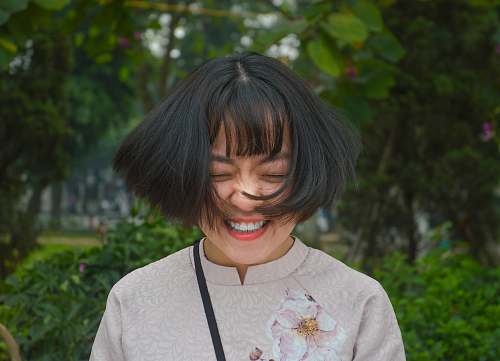 people woman smiling closing eyes while flipping her hair person