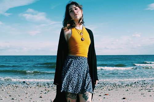 people woman standing along seashore water