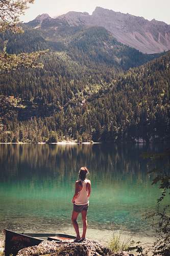 person woman standing in front of body of water water