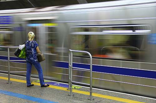 people woman standing in front of train person
