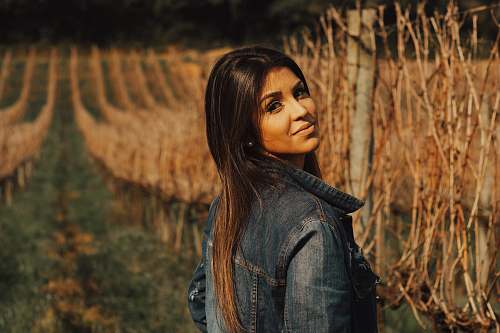 people woman standing near brown vines person