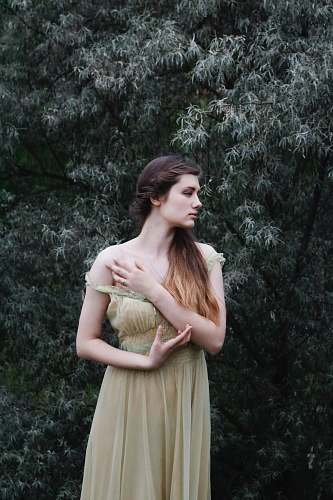 people woman standing near green leafed tree person