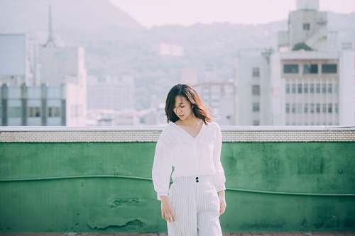 people woman standing near green wall during daytime person
