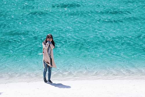 people woman standing near seashore during daytime person
