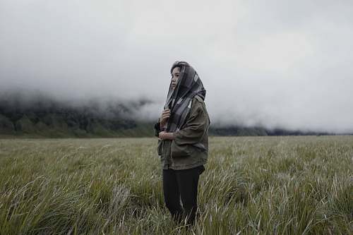 person woman standing on grasses people