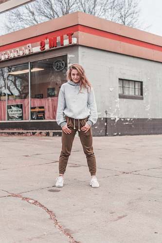 people woman standing on gray concrete surface during daytime person