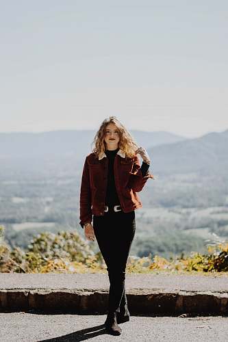 people woman standing on road holding her hair person