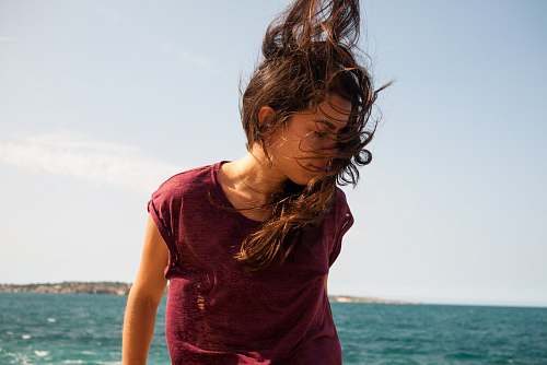 people woman standing while her hair is blown girl