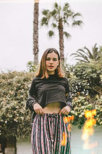 people woman standing while wearing black crop top person