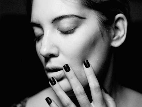 people woman touching her face black-and-white