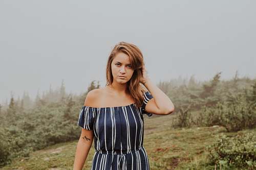 people woman touching her hair during daytime person