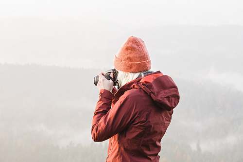 people woman using DSLR camera person