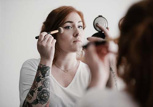 people woman using makeup person