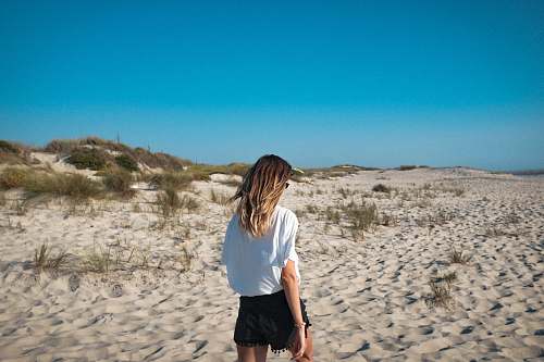 people woman walking on sand pavement person