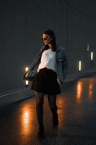 people woman walking through concrete road person