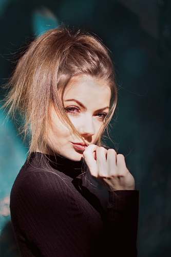 people woman wearing black sweater person