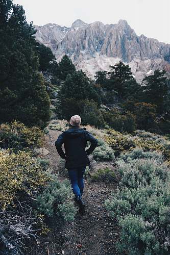 people woman wearing black top walking on soil person