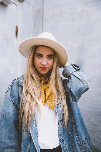 people woman wearing blue denim jacket and white hat hat