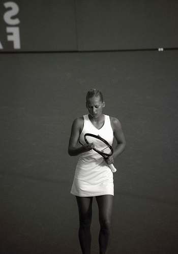 people woman wearing dress holding tennis racket black-and-white