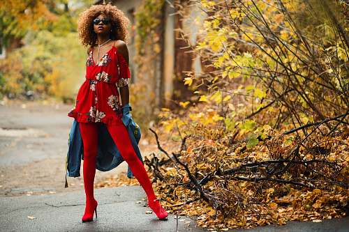 people woman wearing red stockings standing beside plant person