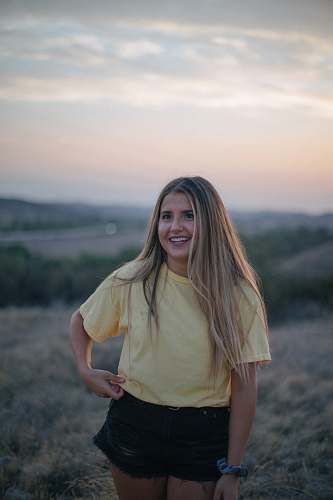 person woman wearing yellow shirt and black shorts at the field people
