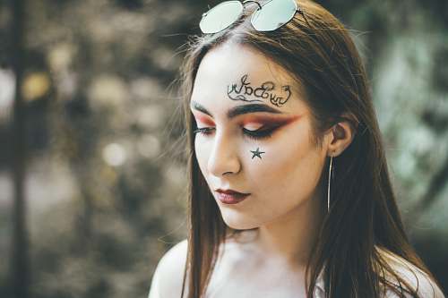 people woman with face paint wearing sunglasse s person