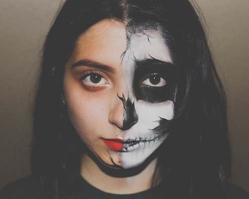 people woman with skull paint on her half face person