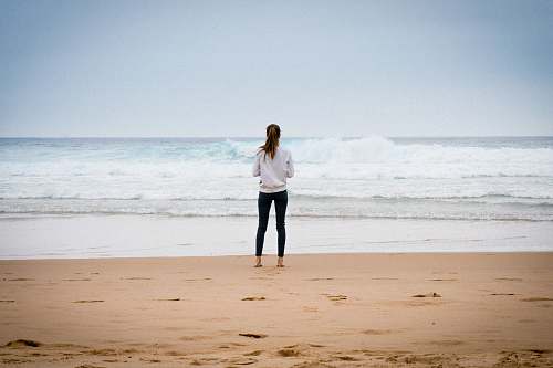 beach woman standing near seashore during daytime sea