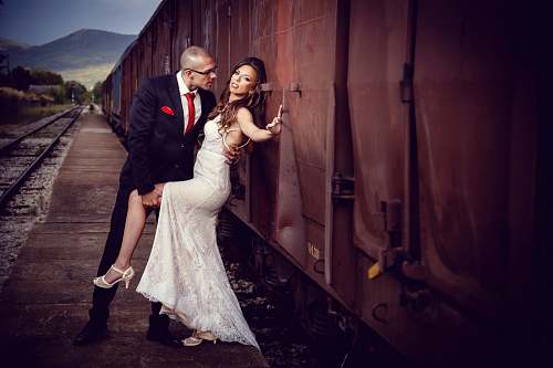 human bride and groom beside train during daytime person