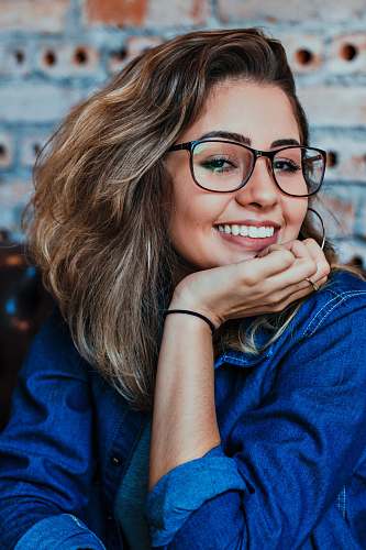 person closeup photo of woman wearing black framed eyeglasses human