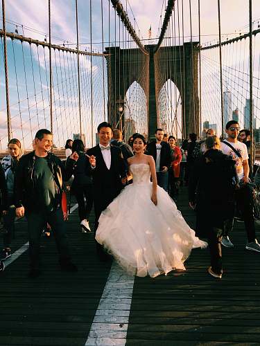 human couple standing on suspension bridge person