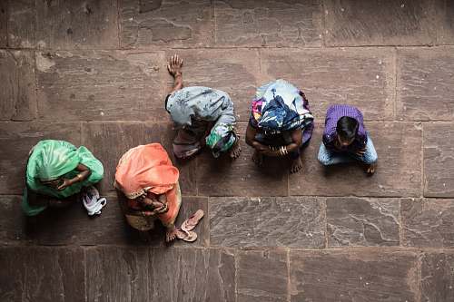 human five person sitting on concrete floor person