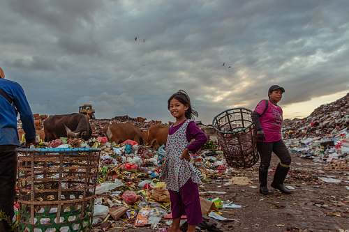 human girl standing near garbage person