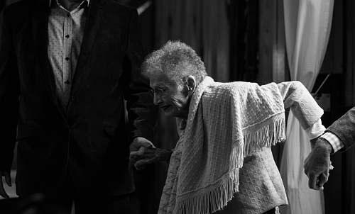 person grayscale photo of woman with scarf black-and-white
