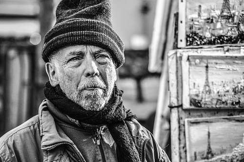 person grayscale photography of man with beanie cap and scarf black-and-white